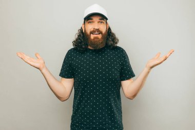 A photo of an confused man looking at the camera