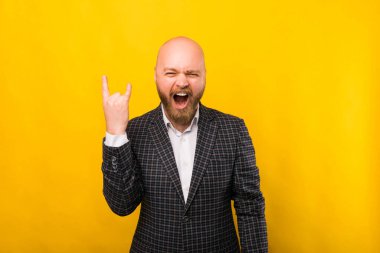 A photo of a business man screaming at the camera rock and roll