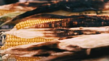 Close up footage of chef making some grilled corn on grill.