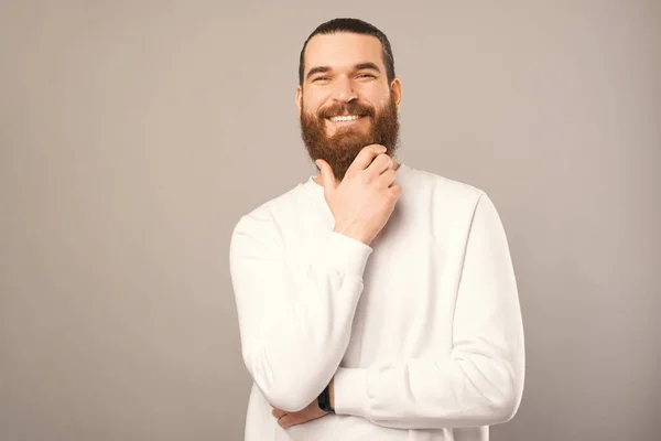Handsome Confident Man Touching His Beard While Smiling Camera Studio — Stockfoto