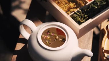 close up video of woman making some herbal tea in pot.