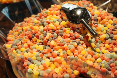 Satın alınmaya hazır bir dükkanda renkli jöle ya da şekerlerin etrafında marmelat. İç çekim..