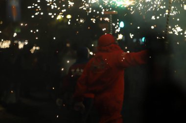 man with a red lantern in the night