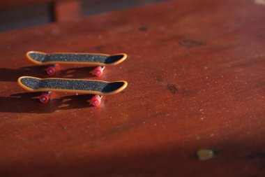 two mini finger skateboards on the table