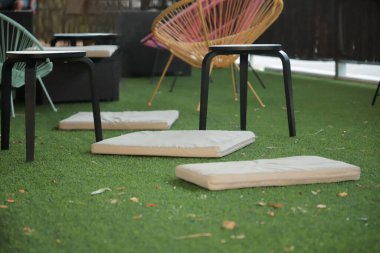 chillout area with green grass and designer chairs