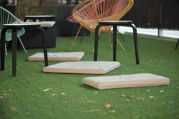 chillout area with green grass and designer chairs