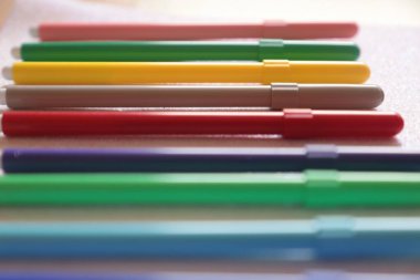 close up of a child writing notes with a pencil on it