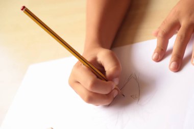 hand drawing of a child with a pencil on a white background