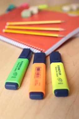 a closeup shot of school supplies on a blue background