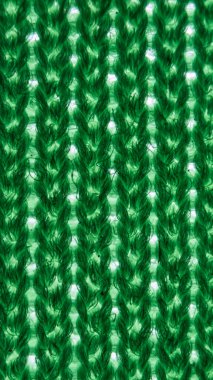 Yeşil ve beyaz sentetik fiber soyut arka plan. Tekstil dokusunun makro deseni. Giysi endüstrisi, kumaşı giyime karşı korumak için polyesterle çeşitli doğal kumaşları birleştiriyor..