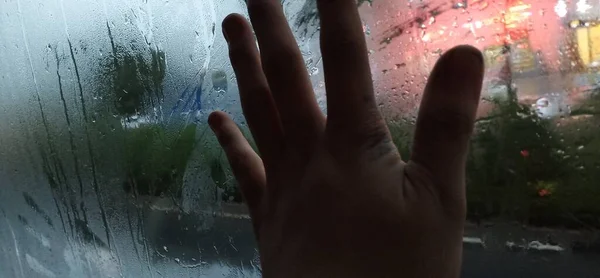 a man with a glass of water in the rain