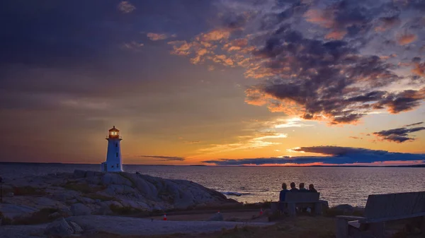 lighthouse at sunset, the sea, the sun sets, the sky and the moon, the light