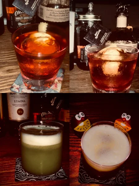 a glass of whiskey with a cocktail and a cup of coffee