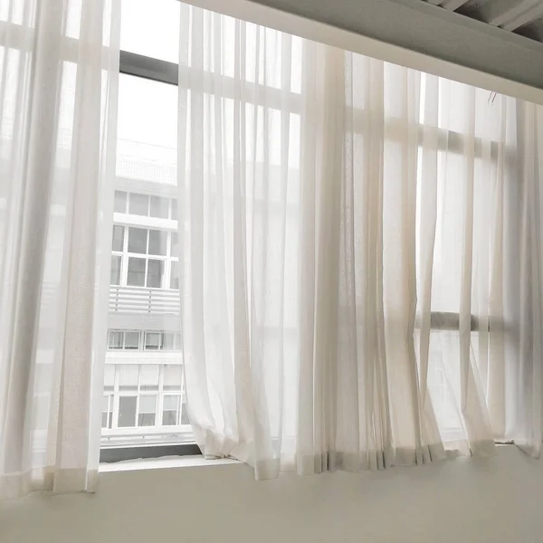 white curtains on the window sill