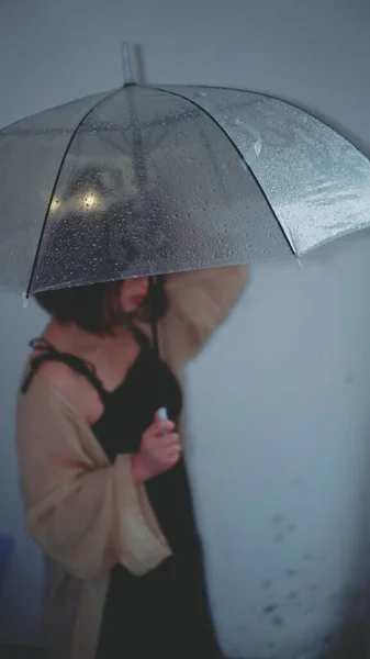 a man in a black jacket and a raincoat with a hood