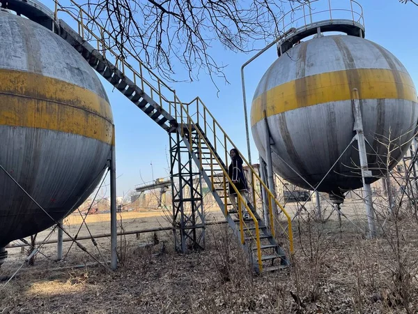 oil tanks and barrels of water in the countryside