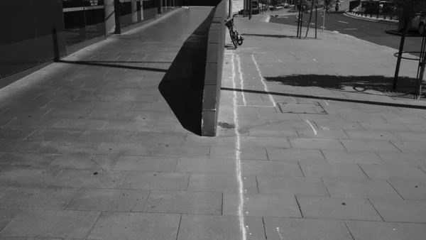 black and white photo of a street with a pedestrian