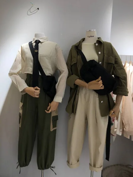 mannequin in a suit and a jacket in a shop