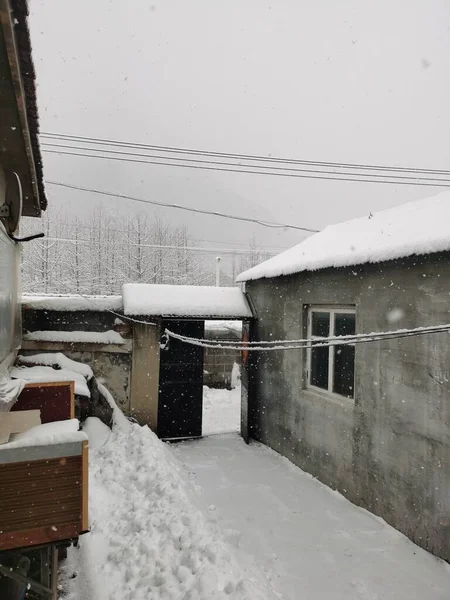 old wooden house in the snow