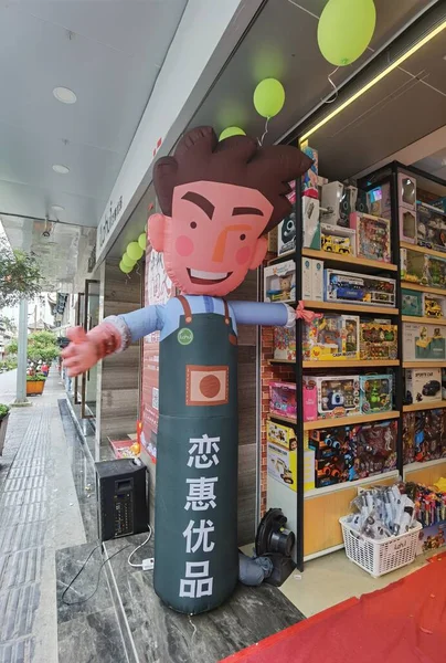 a man in a shop with a shopping cart