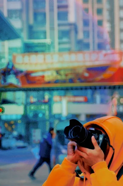 a man in a suit with a camera on the background of the city