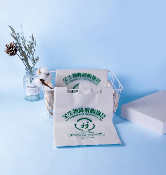 white paper bag with blue ribbon on a turquoise background