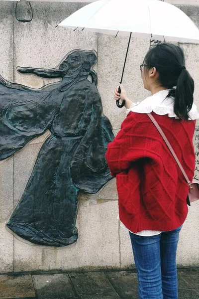 young woman with umbrella in the city