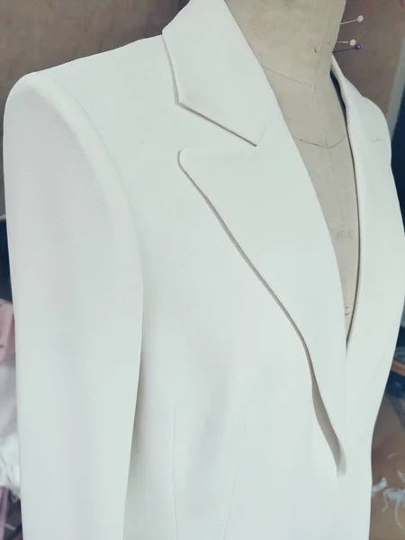 close up of a white shirt on a mannequin