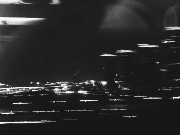 black and white photo of a sea with a lot of lights