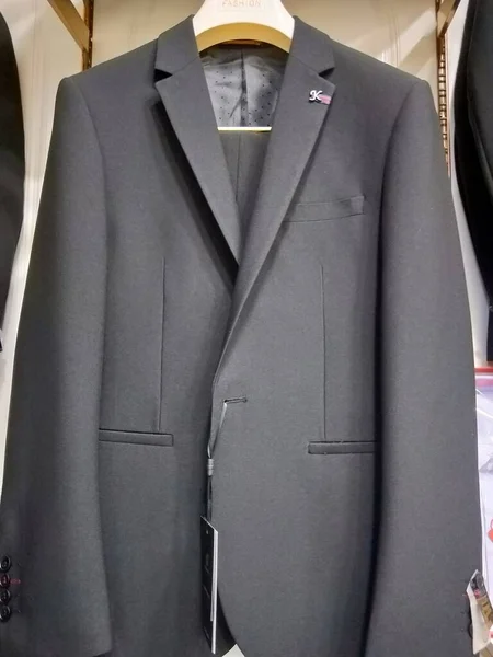 men\'s suit with a mannequin in a shop