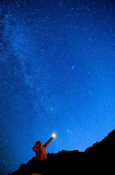 silhouette of a man in a suit with a star on the background of the mountains