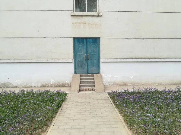 old wooden fence with a white wall