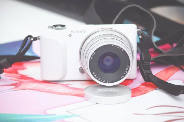 camera, travel, vacation, tourism, technology concept. close up of laptop, cup and coffee