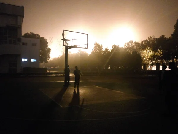 silhouette of a basketball player on the street