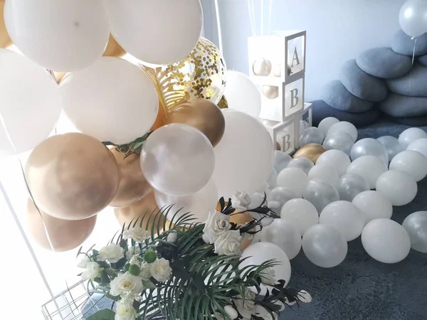 beautiful white balloons and flowers in a room