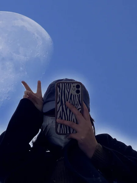 man with a mask on the background of the moon