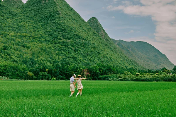 young couple in love walking in the mountains