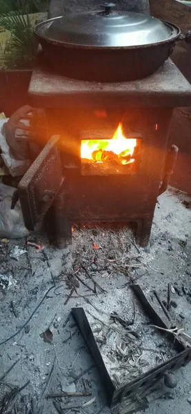 a closeup shot of a burning fire in a metal pot