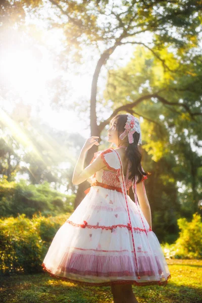 beautiful young woman in a dress with a veil in the park