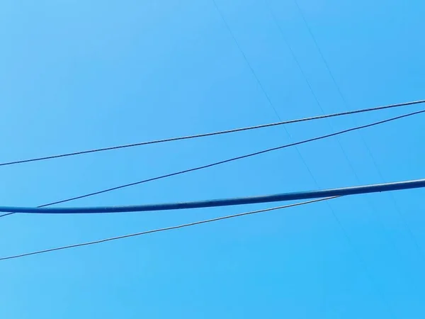 high voltage post on the background of blue sky