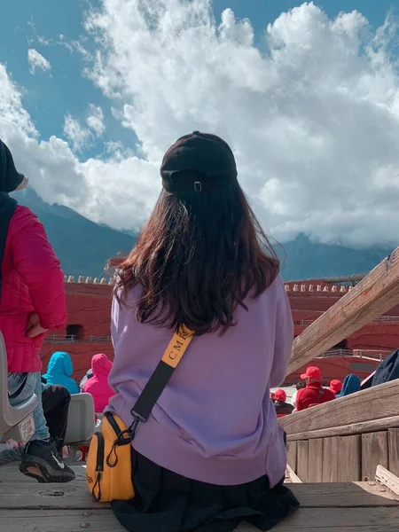 young woman with backpack and backpacks on the mountain