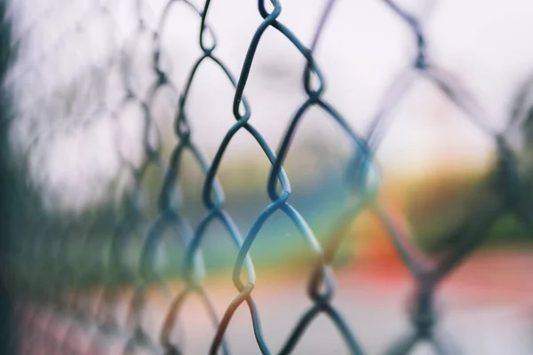 barbed wire fence with net and blur background