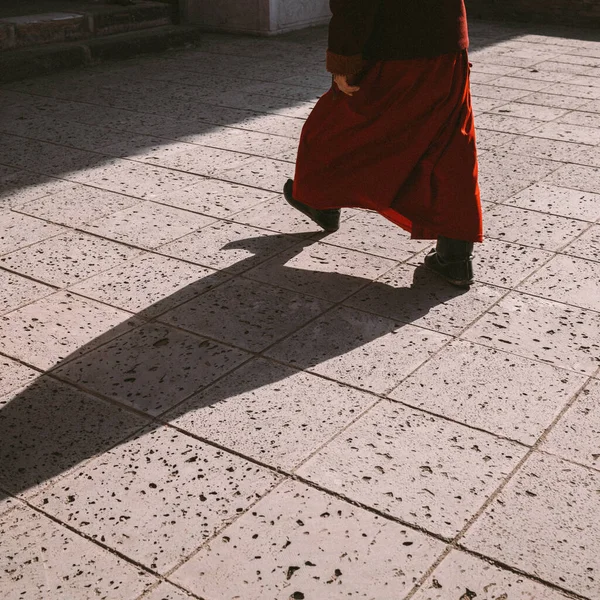 a man in a dress walks in the city