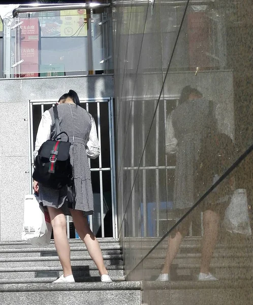 young woman with a backpack walking in the city