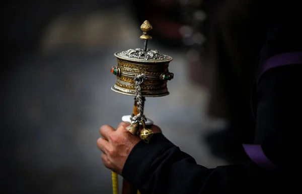 man holding a candle in the hands of a hookah