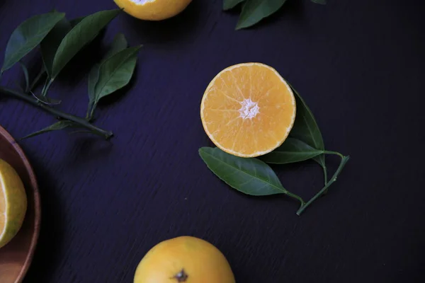 fresh ripe fruits on a black background. top view.