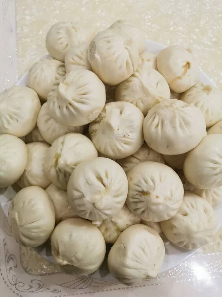 fresh raw dumplings on a white plate