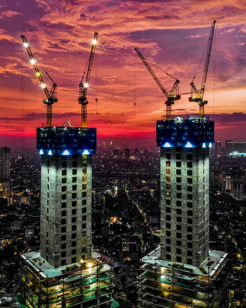 construction cranes and building under the sky