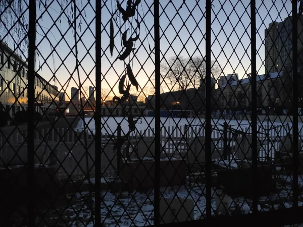 silhouette of a prison fence
