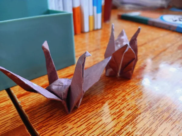 a small bird is a handmade paper boat